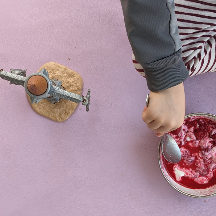 Child eating on a lavender Studio Huske silicone play mat, Switzerland