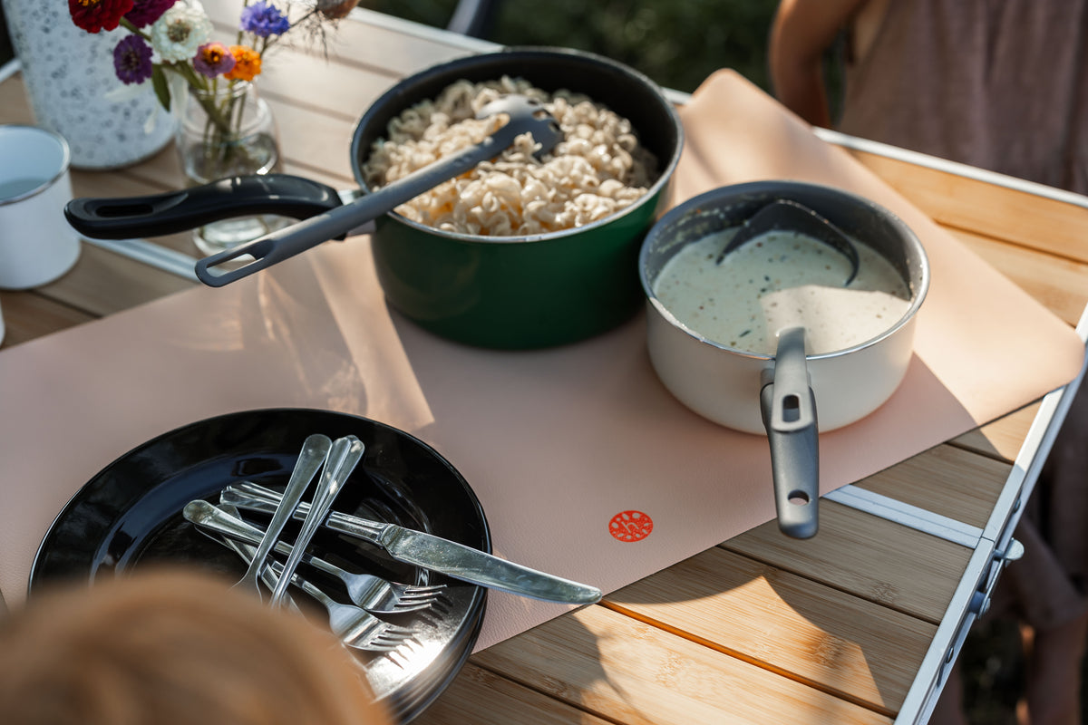 Studio Huske play mat — blush mat as table protector with pasta dinner at campsite