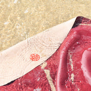 Explore Beige/Wine large round silicone play mat, blush sand huske mat partially submerged in shallow crystal clear ocean