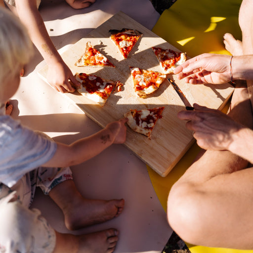 Explore Beige/Wine large round silicone play mat, family sharing pizza on the mat in the mountains