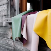 Explore Beige/Wine large round silicone play mat, mats draped over a cabin railing