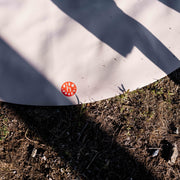 Explore Beige/Wine large round silicone play mat, sunlit mat edge with the logo on mountain ground