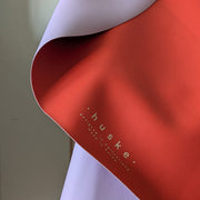 Roam Round Lilac/Red silicone splat mat, lilac face folded back to show the red reverse and logo