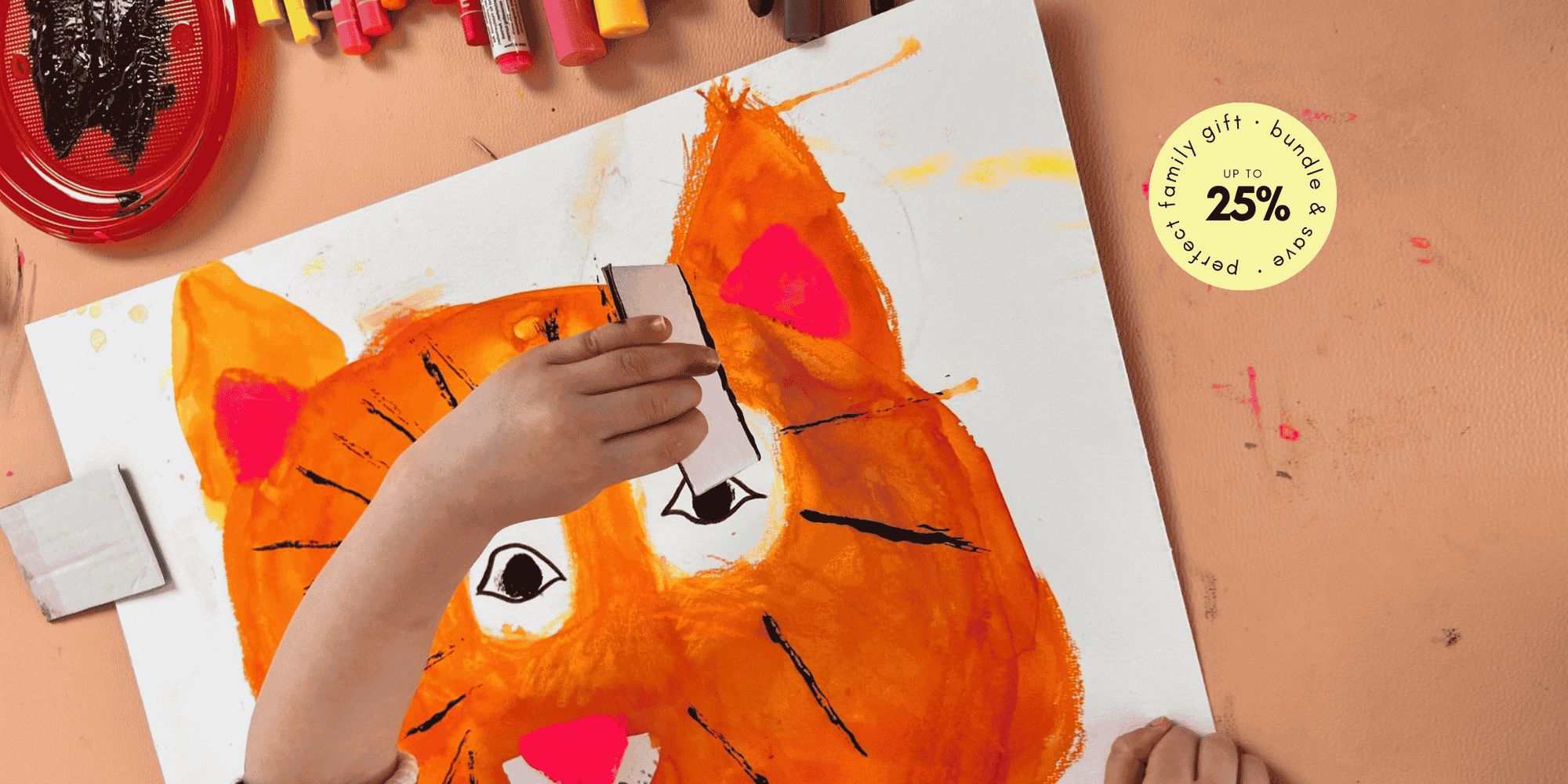 Child painting on Studio Huske mat, close framing shows texture and tools.