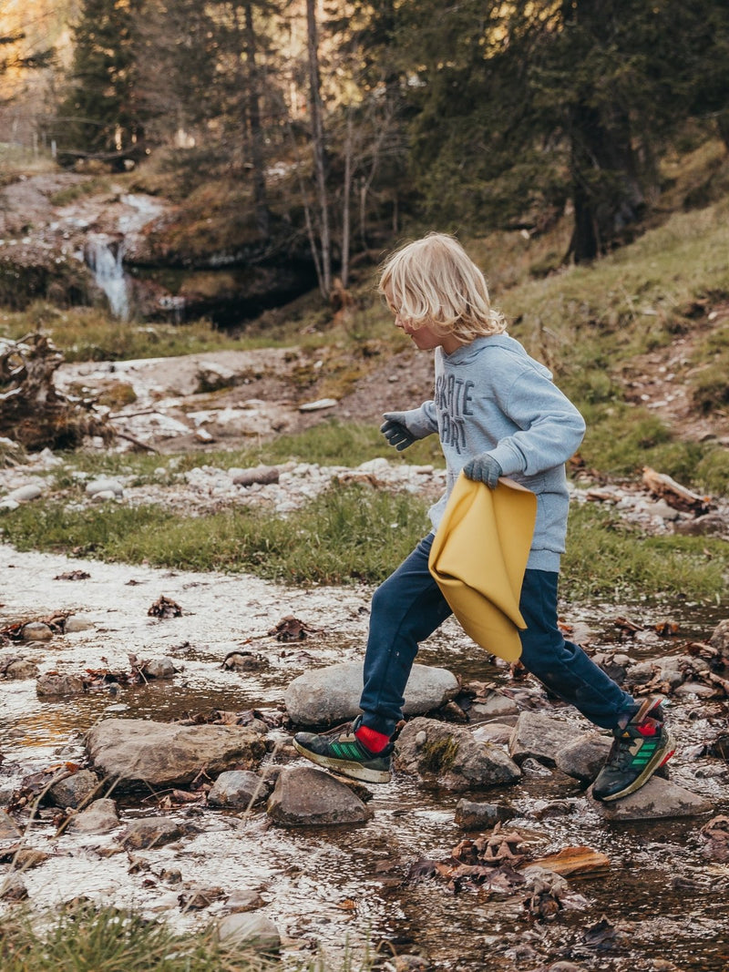 Close-up of Studio Huske mat folded outdoors in soft mountain light.