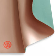 Wriggle silicone changing mat and placemat in Peach/Green, real silicone leather texture with the sage green face folded over