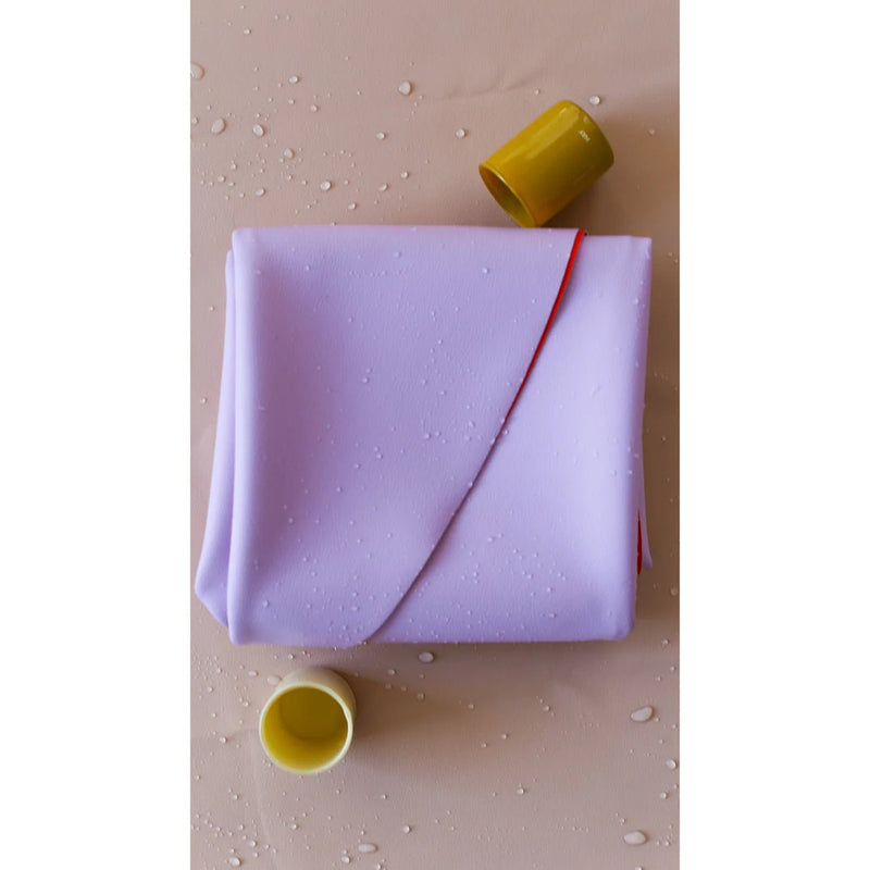 Vegan leather play mat in soft lavender color with yellow cups, ideal for family play and sensory activities.