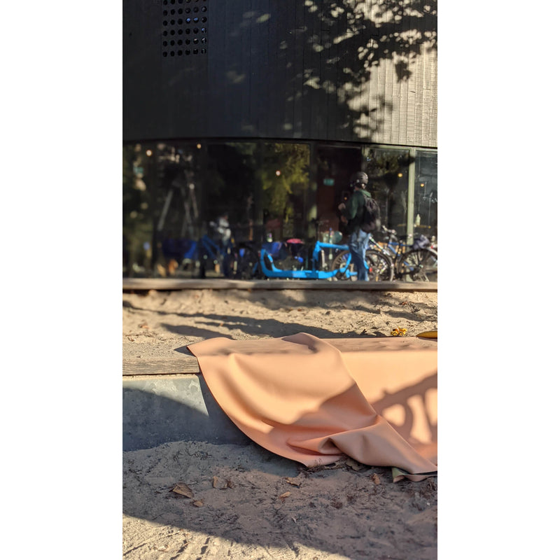 Vegan leather play mat displayed in a bright outdoor setting, blending comfort and style for family play.