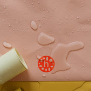 Silicone leather play mat with water droplets, showcasing its wipe-clean surface for easy maintenance.