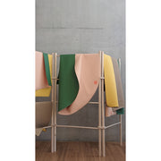 Silicone leather play mat displayed on a rack, showcasing soft, minimal colors for children's play areas.