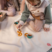 Children playing on an extra large waterproof silicone mat, engaging in sensory play with colorful toys.
