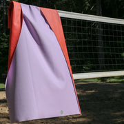 Extra large waterproof silicone mat, Gallivant Mat (XL) hanging on a volleyball net in natural setting.
