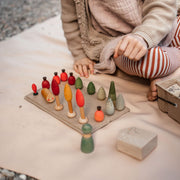 Child playing with colorful wooden toys on an extra large waterproof silicone mat, Gallivant Mat (XL).