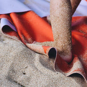 Large round waterproof play mat in use at the beach, showcasing its sand-resistant surface and vibrant color.