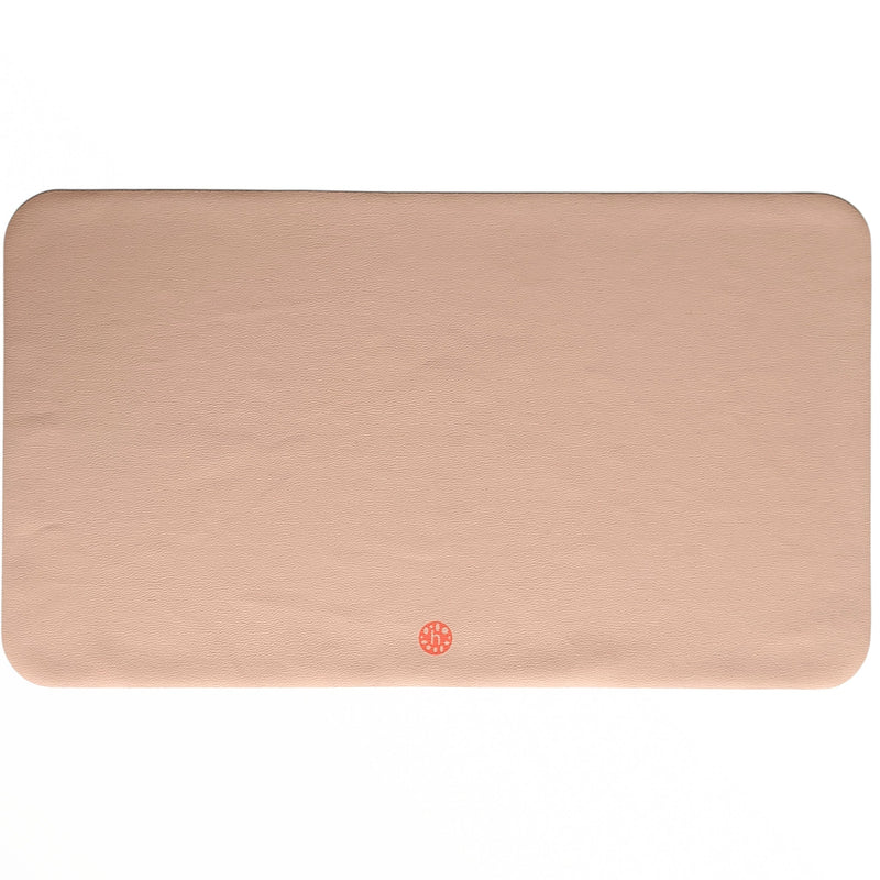 Waterproof silicone leather changing mat, Wriggle Mat (S) in a soft peach color, perfect for changing and play.