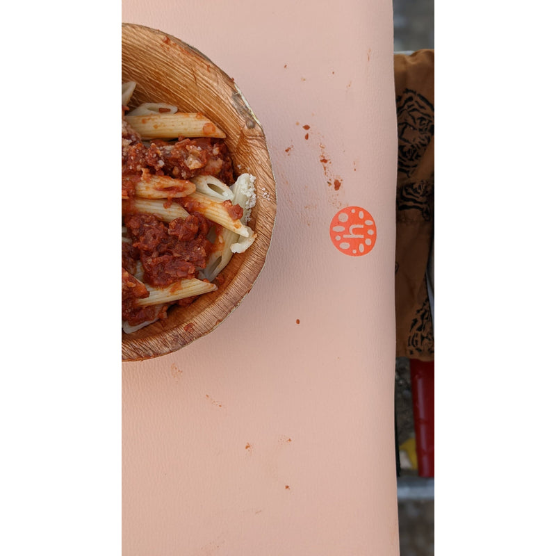 Waterproof silicone leather changing mat with a bowl of pasta and sauce, demonstrating its easy-to-clean surface.