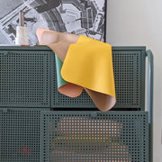 Colorful waterproof silicone leather changing mat draped over a storage unit, highlighting its modern design.