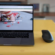 Waterproof silicone leather changing mat displayed under a laptop and mouse on a table.