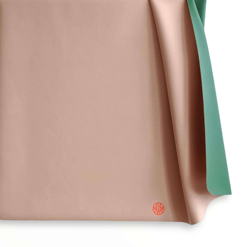 Waterproof square play mat for children, Roam Mat, showcasing a soft silicone texture in pink and green.
